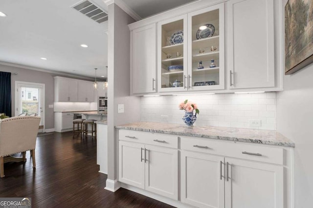 6840 Canyon Creek Way, Cumming, GA 30028 - bar featuring ornamental molding, backsplash, dark wood-style floors, stainless steel oven, and recessed lighting
