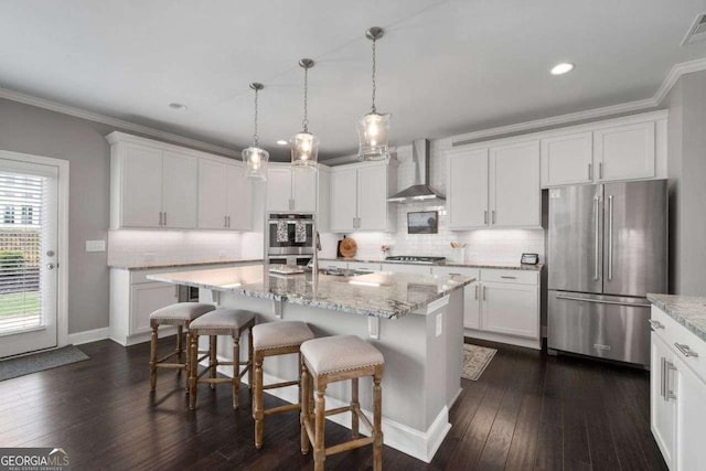 6840 Canyon Creek Way, Cumming, GA 30028 - kitchen featuring appliances with stainless steel finishes, wall chimney range hood, crown molding, dark wood finished floors, and white cabinetry