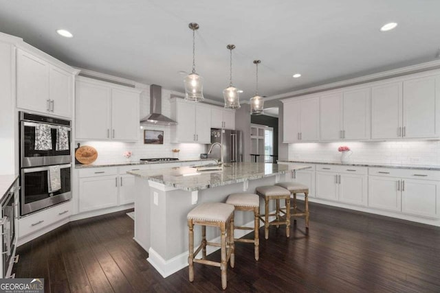 6840 Canyon Creek Way, Cumming, GA 30028 - kitchen with wall chimney exhaust hood, stainless steel appliances, backsplash, white cabinets, and recessed lighting