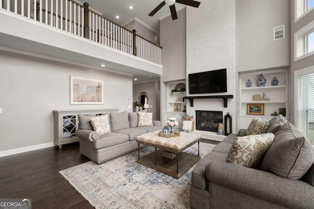 6840 Canyon Creek Way, Cumming, GA 30028 - living area with a high ceiling, a fireplace, ceiling fan, dark wood finished floors, and built in features