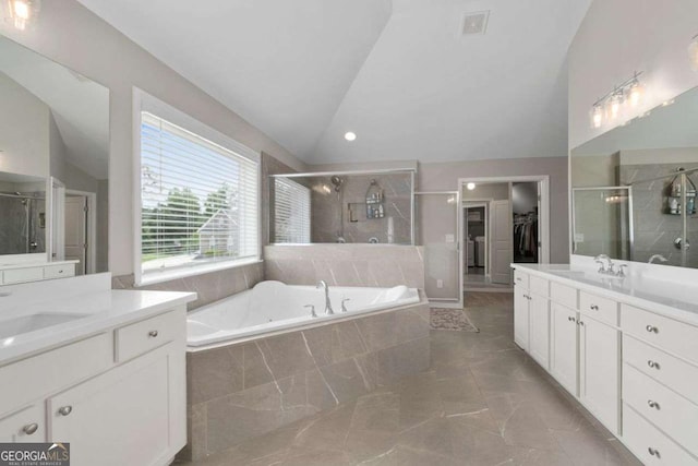 6840 Canyon Creek Way, Cumming, GA 30028 - bathroom featuring lofted ceiling, two vanities, a shower stall, a garden tub, and a walk in closet