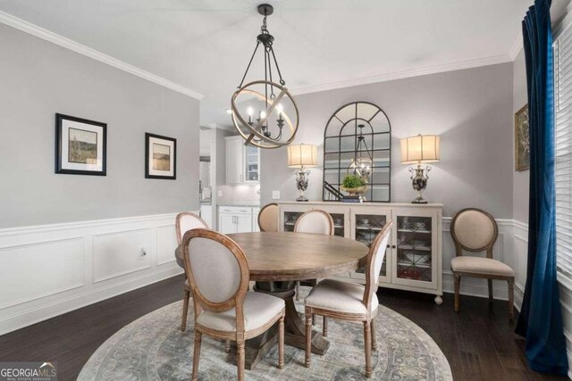 6840 Canyon Creek Way, Cumming, GA 30028 - dining space with dark wood-style floors, a chandelier, ornamental molding, wainscoting, and a decorative wall