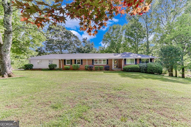 ranch-style house with a front lawn and brick siding
