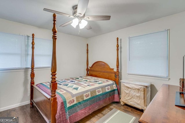 bedroom with wood finished floors, a ceiling fan, and baseboards