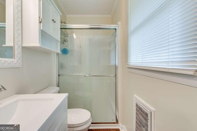 full bath featuring a shower stall, toilet, crown molding, and vanity