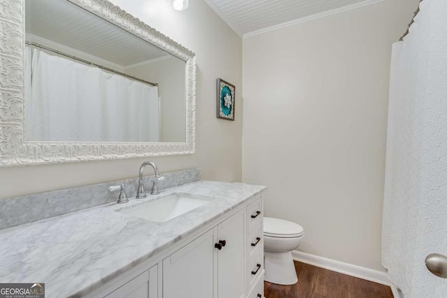 full bathroom with wood finished floors, toilet, vanity, ornamental molding, and baseboards