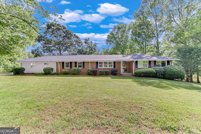 single story home featuring brick siding and a front lawn