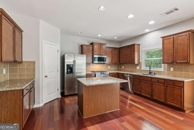 5655 Stevehaven Ln, Cumming, GA 30028 - kitchen with appliances with stainless steel finishes, a sink, dark wood-style flooring, tasteful backsplash, and recessed lighting