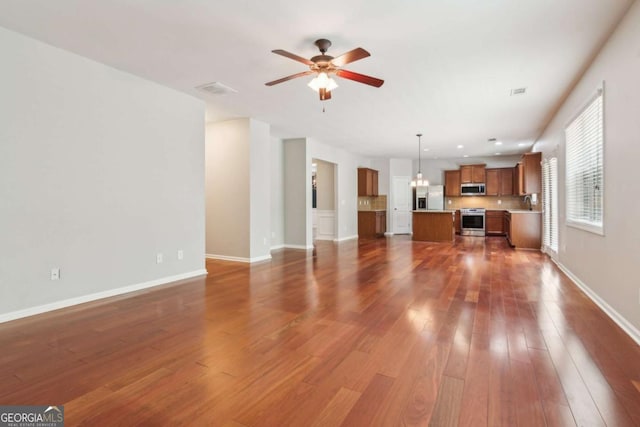 5655 Stevehaven Ln, Cumming, GA 30028 - unfurnished living room with a ceiling fan, dark wood-type flooring, and baseboards