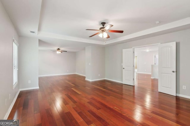 5655 Stevehaven Ln, Cumming, GA 30028 - empty room with a tray ceiling, a ceiling fan, and wood-type flooring