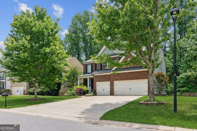5655 Stevehaven Ln, Cumming, GA 30028 - view of front of home with brick siding, concrete driveway, a front lawn, and an attached garage