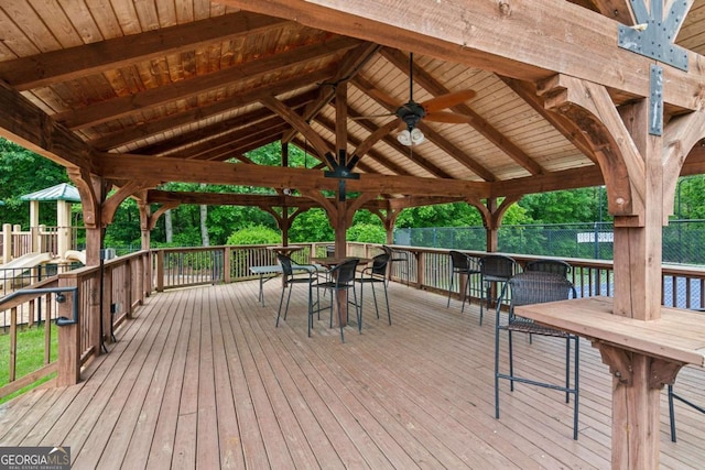 5655 Stevehaven Ln, Cumming, GA 30028 - wooden terrace featuring a gazebo, ceiling fan, outdoor dining area, and fence