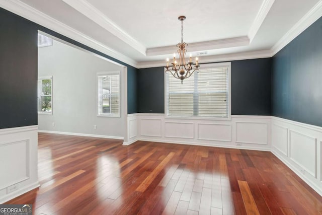 5655 Stevehaven Ln, Cumming, GA 30028 - unfurnished room featuring a chandelier, dark wood-style flooring, a raised ceiling, wainscoting, and ornamental molding