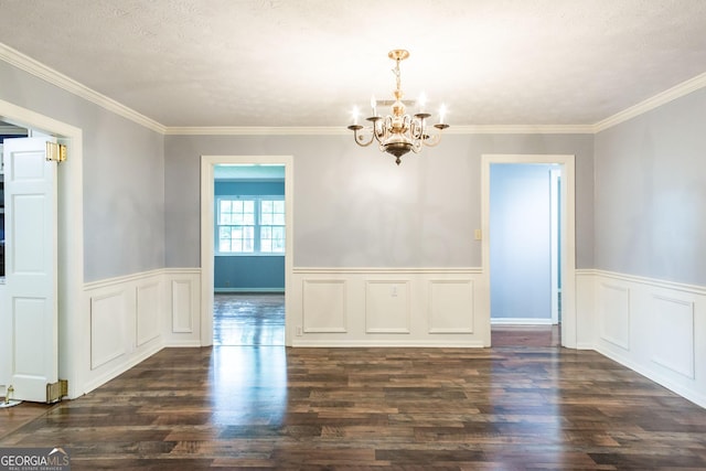 1878 Blalock Ave, Waycross, GA 31503 - unfurnished dining area featuring a chandelier, dark wood-type flooring, a wainscoted wall, crown molding, and a textured ceiling