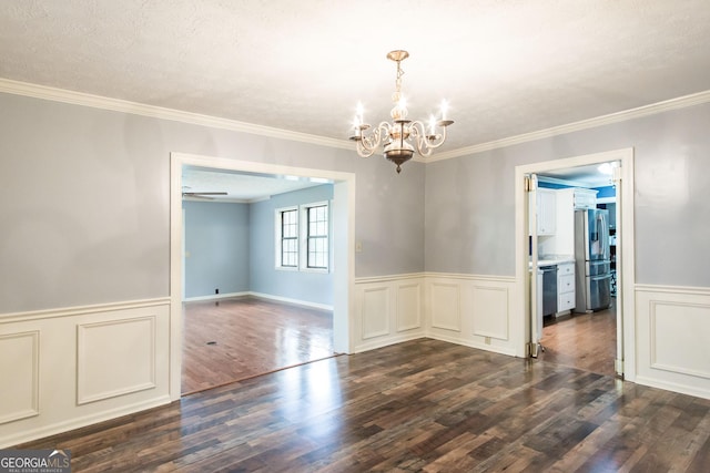 1878 Blalock Ave, Waycross, GA 31503 - empty room featuring a chandelier, dark wood-style flooring, wainscoting, crown molding, and a decorative wall
