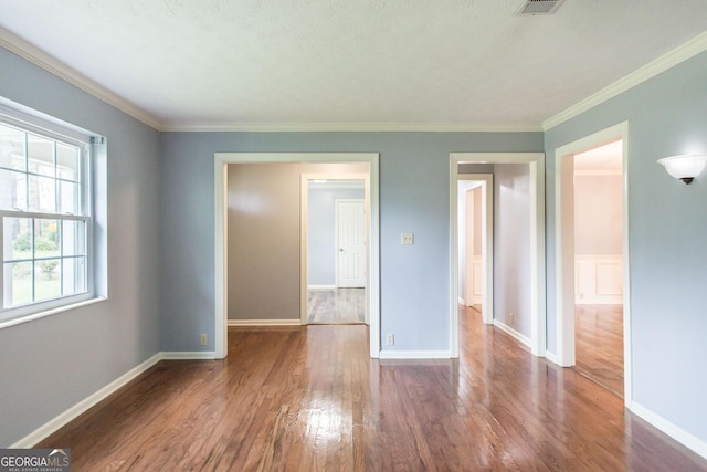 1878 Blalock Ave, Waycross, GA 31503 - spare room featuring wood finished floors, baseboards, and crown molding