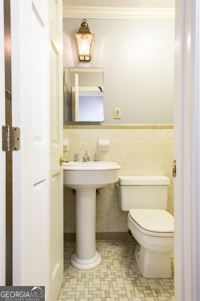 1878 Blalock Ave, Waycross, GA 31503 - half bathroom with toilet, crown molding, and a wainscoted wall