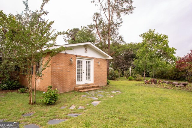 1878 Blalock Ave, Waycross, GA 31503 - view of grassy yard featuring french doors and entry steps
