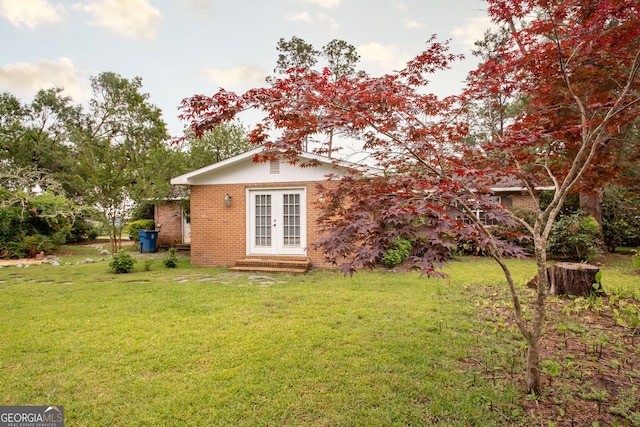 1878 Blalock Ave, Waycross, GA 31503 - rear view of house with french doors, brick siding, a lawn, and entry steps