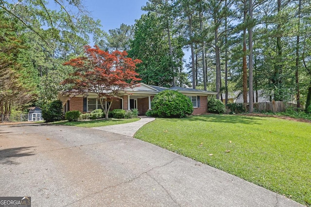 148 Hurt Rd SW, Smyrna, GA 30082 - view of front of home with concrete driveway, brick siding, and a shed