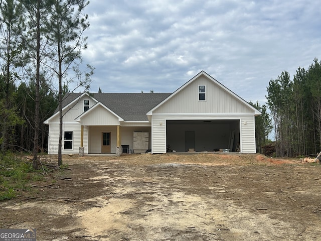 1186 Snow Hill Rd, Cadwell, GA 31009 - view of front facade featuring driveway, a shingled roof, and a garage