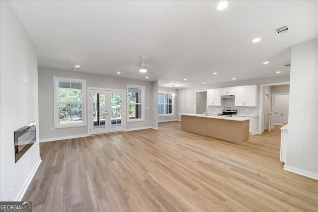 1186 Snow Hill Rd, Cadwell, GA 31009 - unfurnished living room with baseboards, recessed lighting, ceiling fan, light wood finished floors, and heating unit