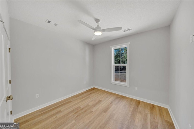 1186 Snow Hill Rd, Cadwell, GA 31009 - spare room featuring light wood-type flooring, a ceiling fan, baseboards, and a textured ceiling