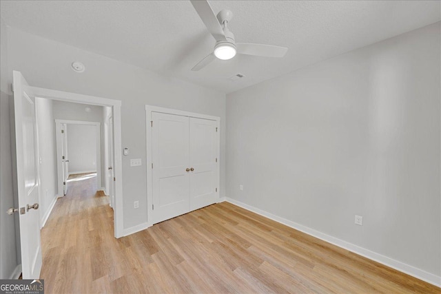 1186 Snow Hill Rd, Cadwell, GA 31009 - unfurnished bedroom featuring light wood-type flooring, baseboards, a textured ceiling, a closet, and a ceiling fan