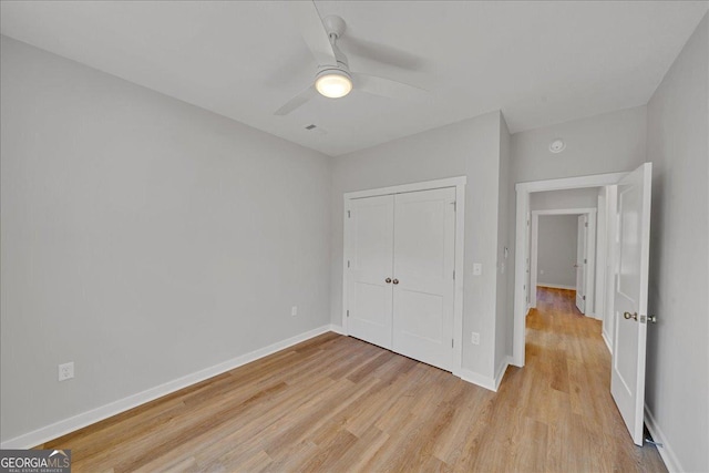 1186 Snow Hill Rd, Cadwell, GA 31009 - unfurnished bedroom with light wood finished floors, baseboards, a closet, and ceiling fan