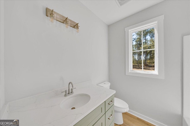 1186 Snow Hill Rd, Cadwell, GA 31009 - bathroom with toilet, vanity, wood finished floors, and baseboards