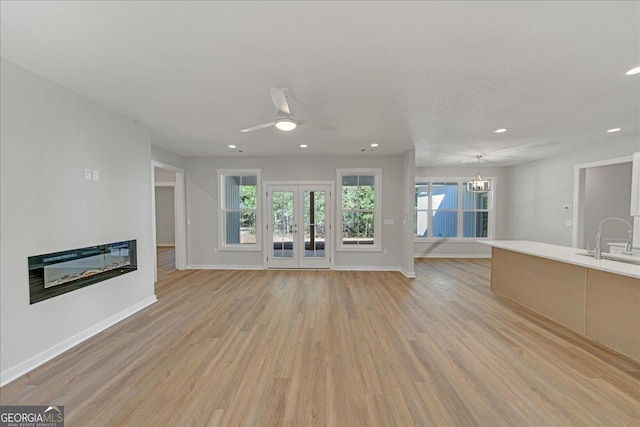 1186 Snow Hill Rd, Cadwell, GA 31009 - unfurnished living room featuring light wood finished floors, ceiling fan, recessed lighting, and healthy amount of natural light