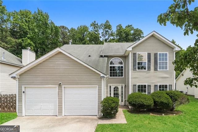traditional-style house with driveway, a garage, and a front yard
