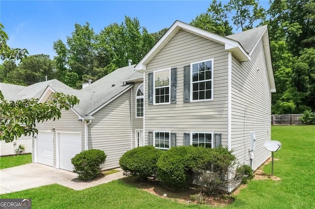 view of front of home with concrete driveway, a garage, a front lawn, and a shingled roof