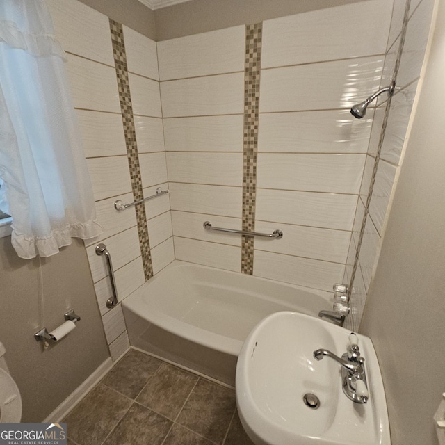 full bath with a sink, shower / bath combination, toilet, and tile patterned floors