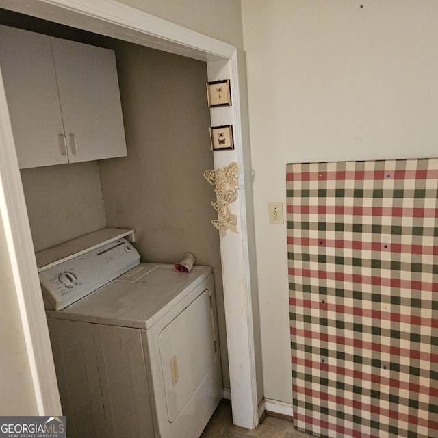 laundry area with washer / clothes dryer, cabinet space, and tile patterned floors