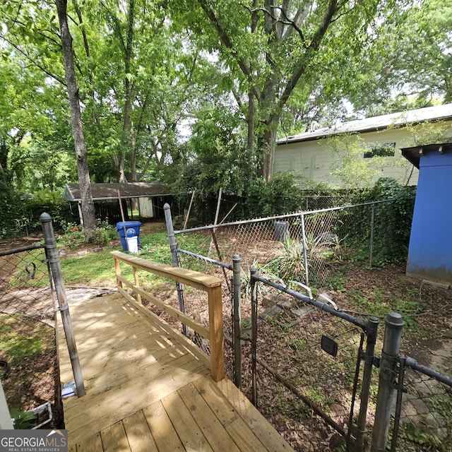 view of yard with fence and a wooden deck