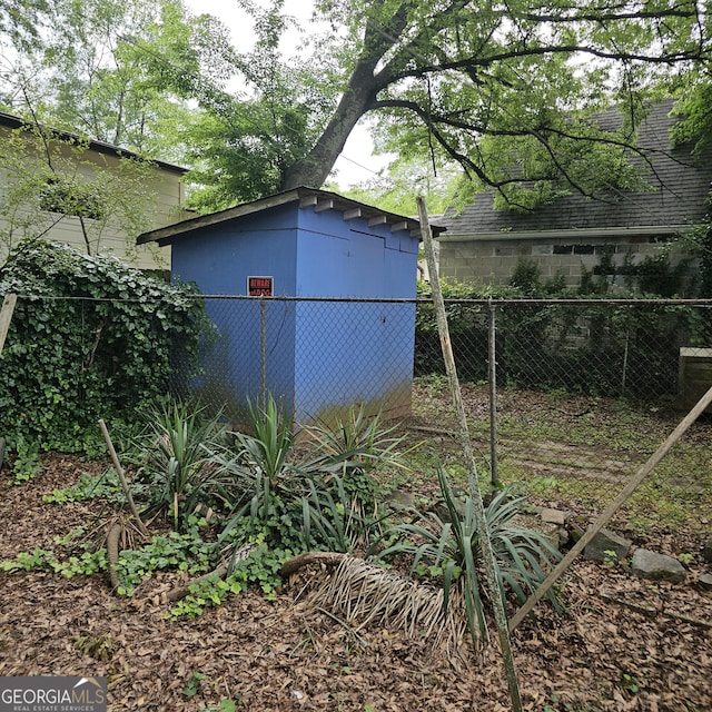 view of outbuilding featuring fence