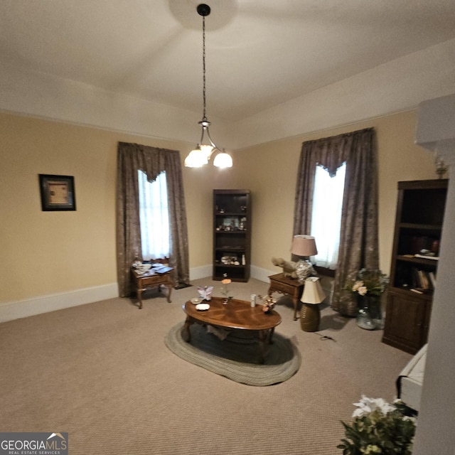 living area with plenty of natural light, carpet, and baseboards