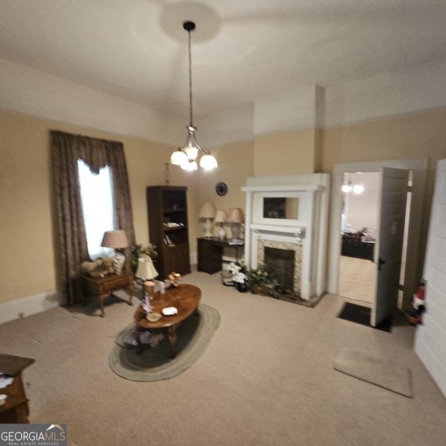 carpeted living area featuring a fireplace and a chandelier