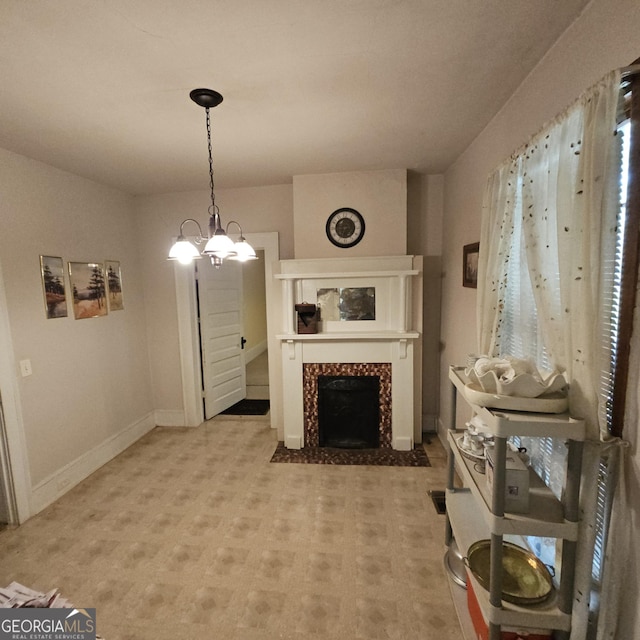 living area with a tiled fireplace and baseboards