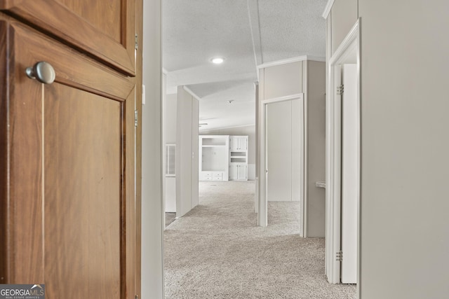 hall with carpet, a textured ceiling, recessed lighting, and crown molding