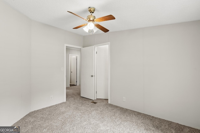unfurnished bedroom featuring carpet floors and ceiling fan