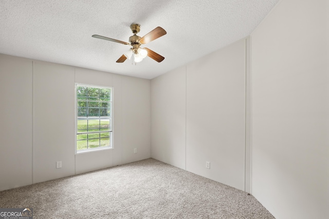 carpeted empty room with a textured ceiling and ceiling fan