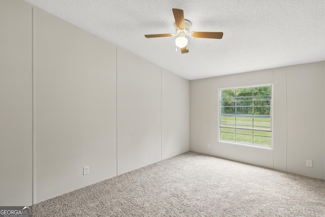 carpeted empty room with a textured ceiling and a ceiling fan