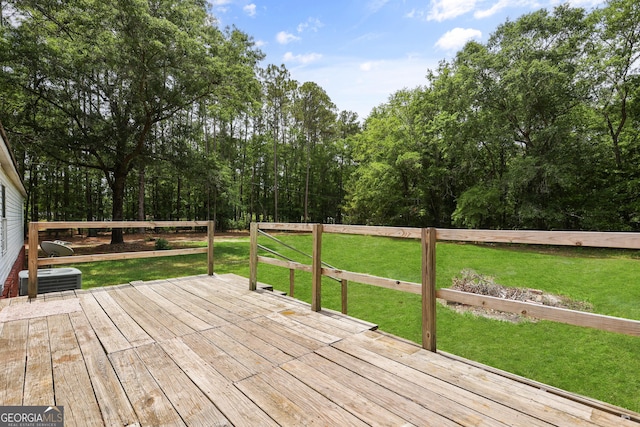 wooden deck with central AC and a lawn