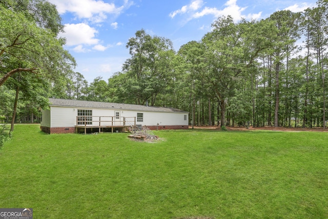 back of house featuring a deck, a yard, and crawl space