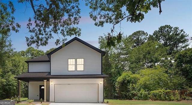 traditional home with a garage and concrete driveway