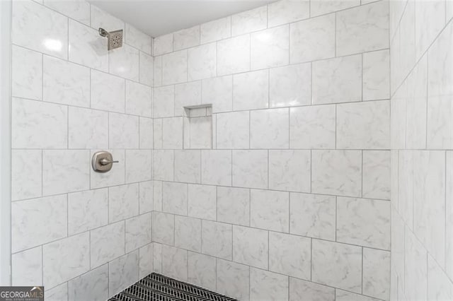 bathroom with a tile shower