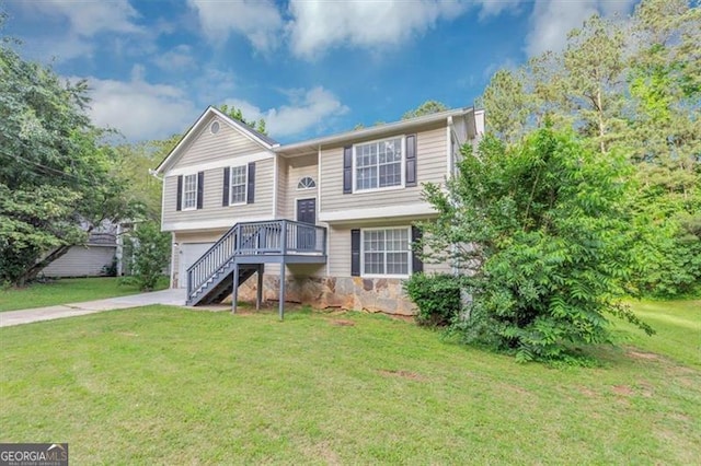 5290 Forest Downs Ln, Atlanta, GA 30349 - raised ranch with a front yard, a garage, driveway, and stairway