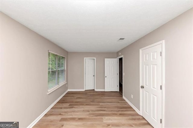 5290 Forest Downs Ln, Atlanta, GA 30349 - unfurnished bedroom with light wood-style floors and baseboards